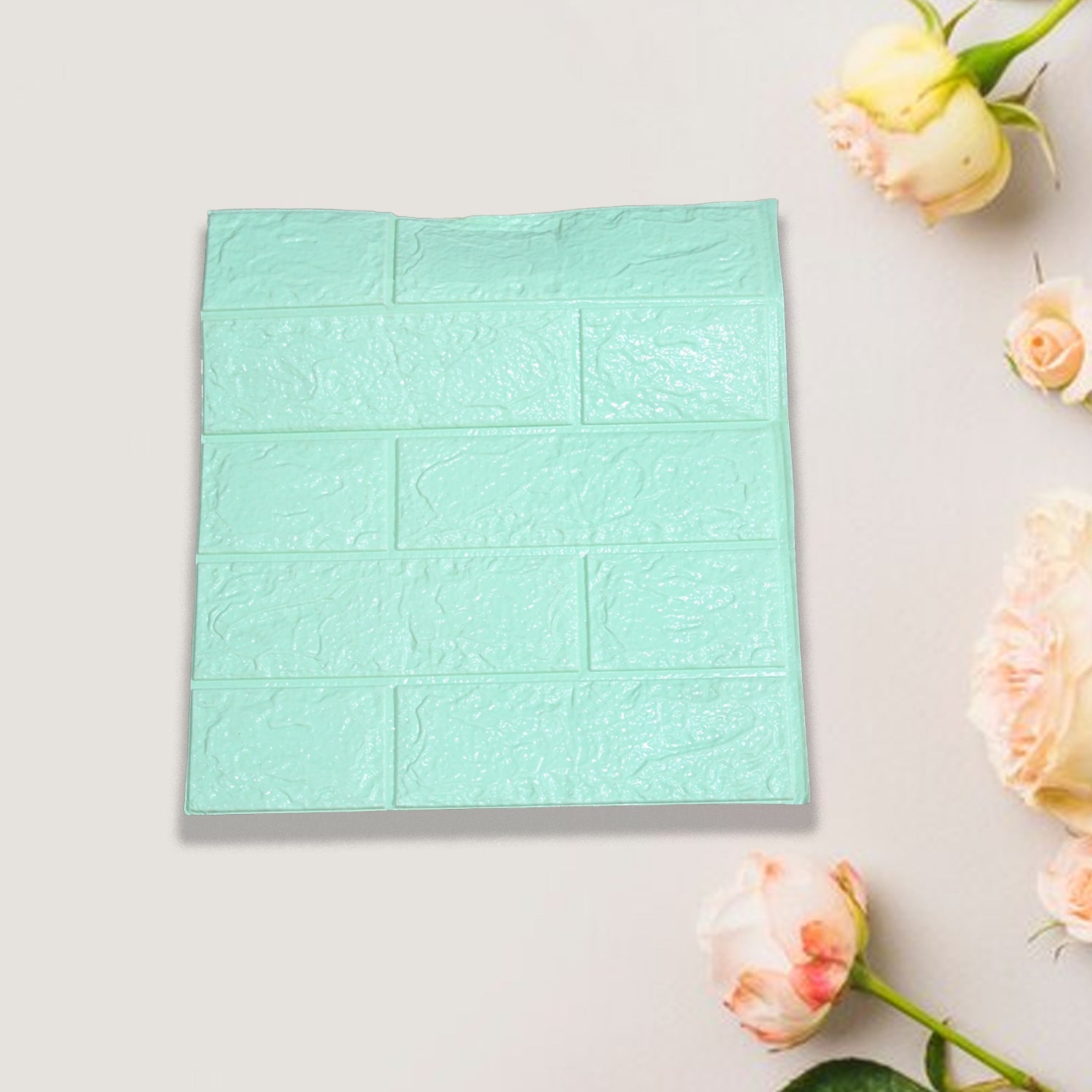 Hand peeling off the protective backing of a self-adhesive wallpaper sheet, ready for easy installation.